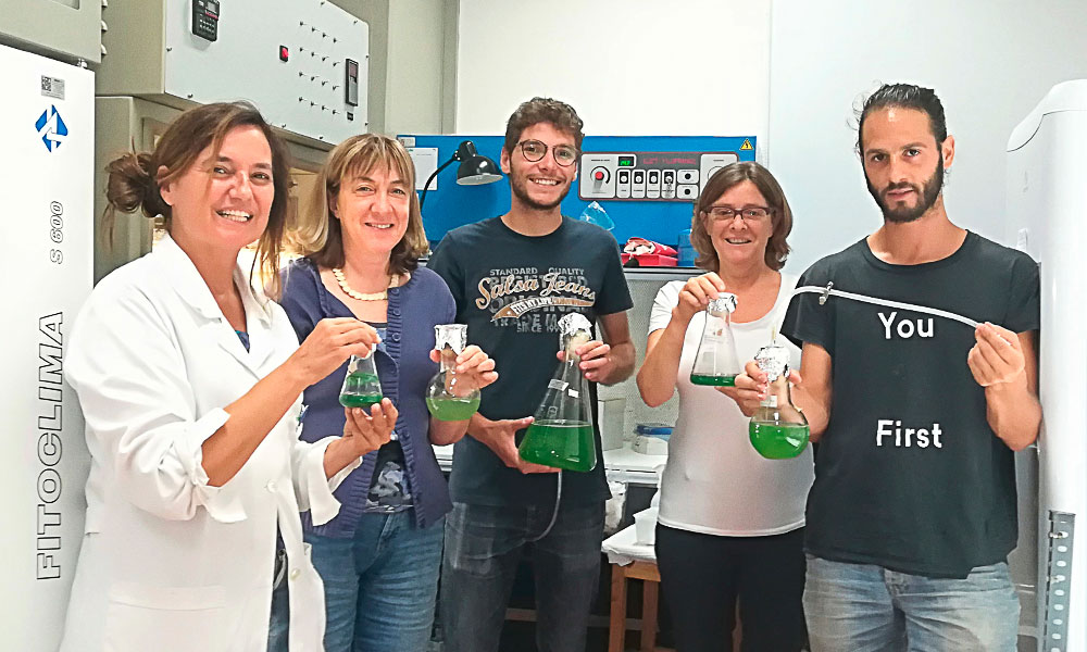 Students holding conical flasks in a lab